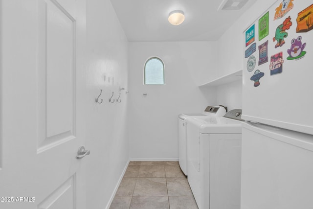 washroom with visible vents, baseboards, laundry area, light tile patterned flooring, and separate washer and dryer