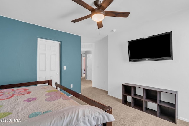 carpeted bedroom with ceiling fan and baseboards