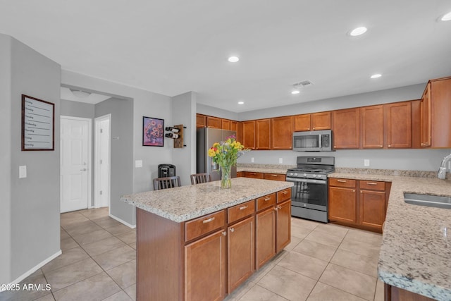 kitchen featuring light tile patterned floors, visible vents, appliances with stainless steel finishes, and a sink