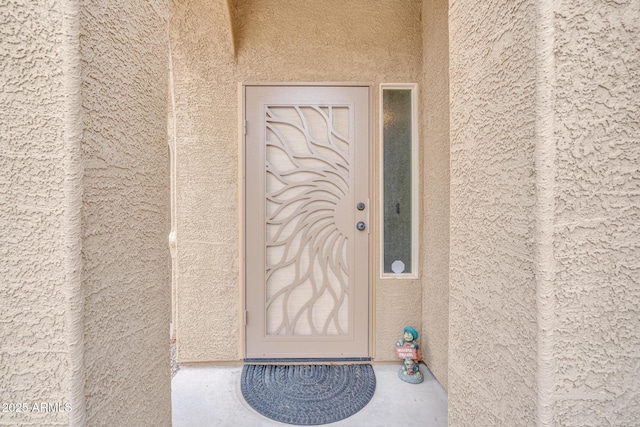 entrance to property with stucco siding