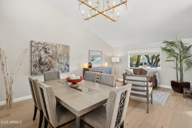 dining room featuring a chandelier, light hardwood / wood-style flooring, and high vaulted ceiling