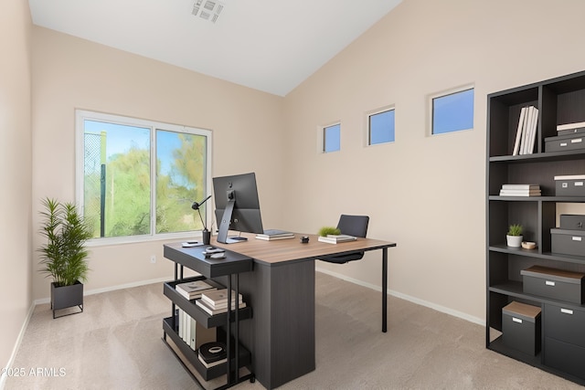 office space featuring lofted ceiling and light colored carpet