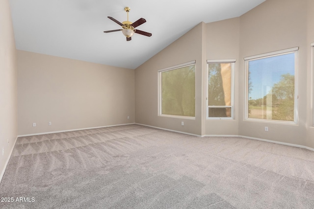 carpeted empty room with high vaulted ceiling and ceiling fan