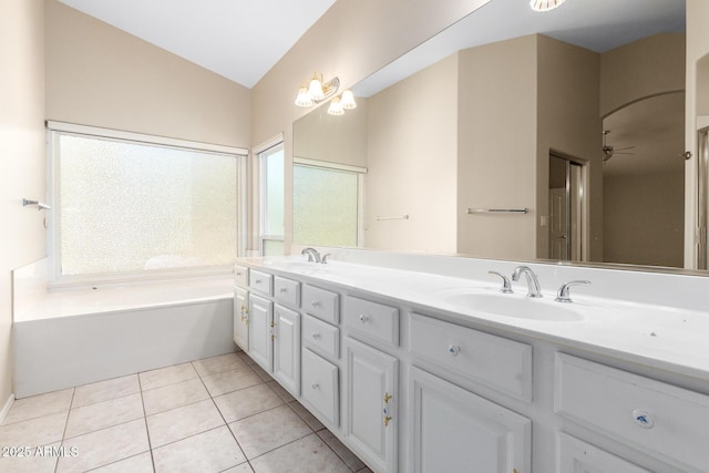 bathroom featuring lofted ceiling, tile patterned flooring, vanity, and a wealth of natural light