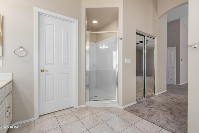 bathroom with vanity, tile patterned flooring, and a shower with door