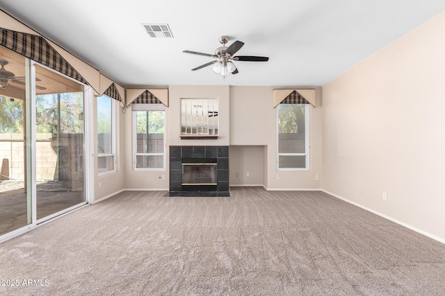 unfurnished living room featuring carpet flooring, a fireplace, and ceiling fan