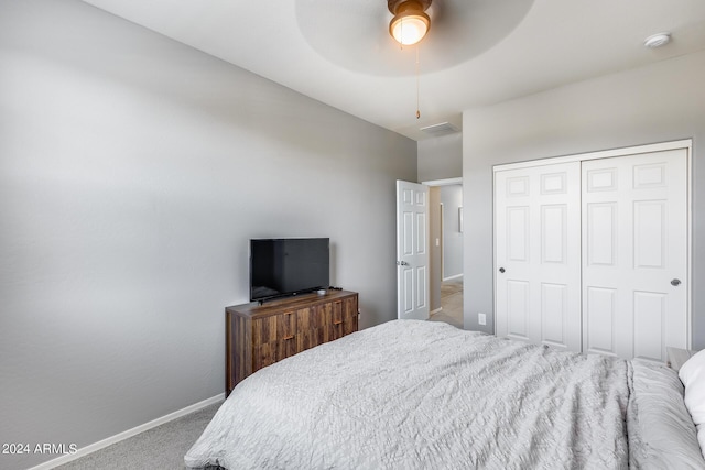 bedroom featuring ceiling fan, light colored carpet, and a closet