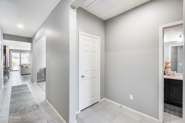 hallway featuring light tile patterned flooring