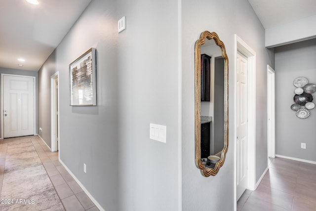 corridor featuring light tile patterned floors