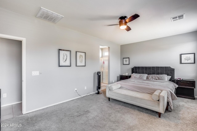 bedroom with carpet floors, connected bathroom, and ceiling fan