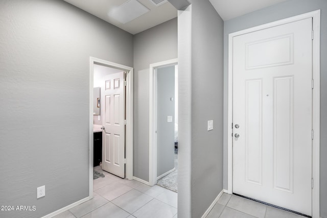 hall featuring light tile patterned floors