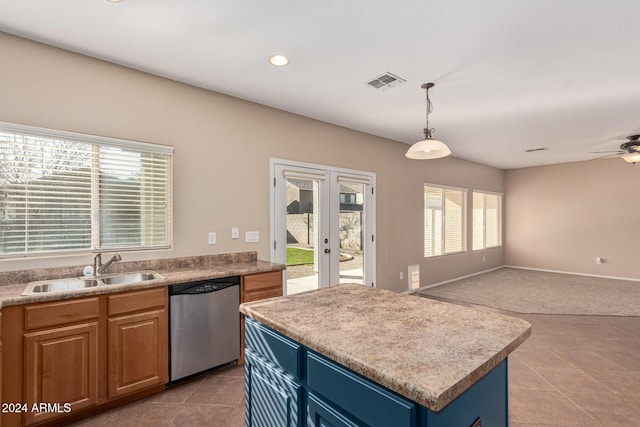 kitchen featuring dishwasher, a kitchen island, a healthy amount of sunlight, and sink