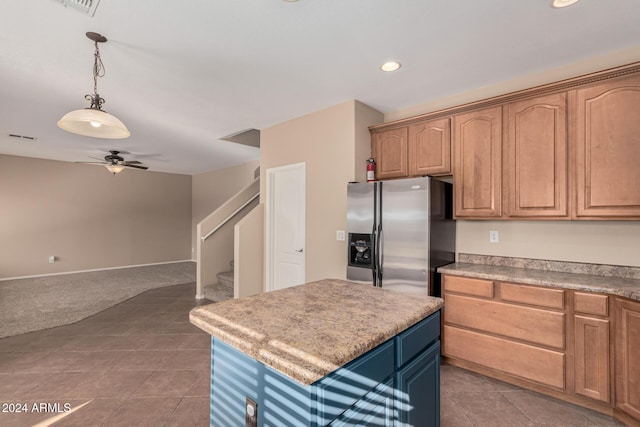 kitchen with a center island, ceiling fan, light tile patterned flooring, and stainless steel fridge with ice dispenser