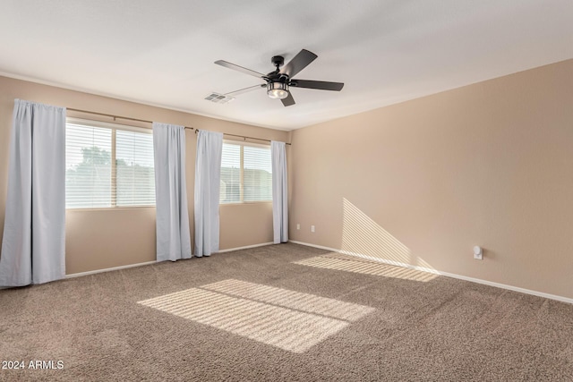 spare room featuring ceiling fan and carpet