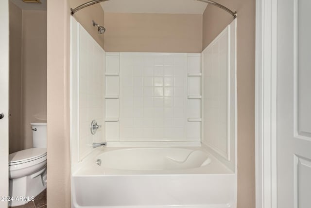 bathroom with bathtub / shower combination and toilet