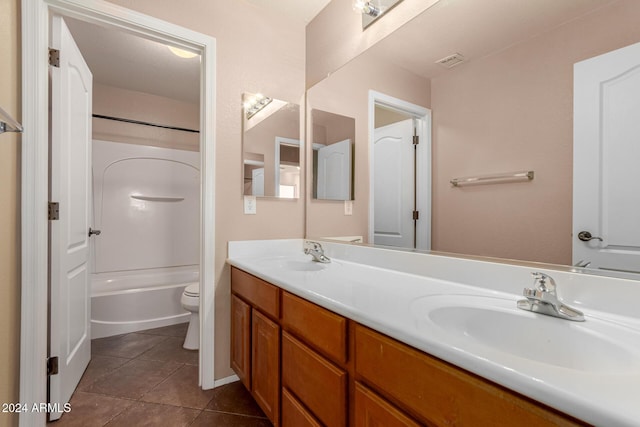 full bathroom featuring toilet, vanity, tile patterned floors, and washtub / shower combination