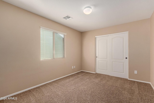 unfurnished bedroom featuring a closet and carpet floors