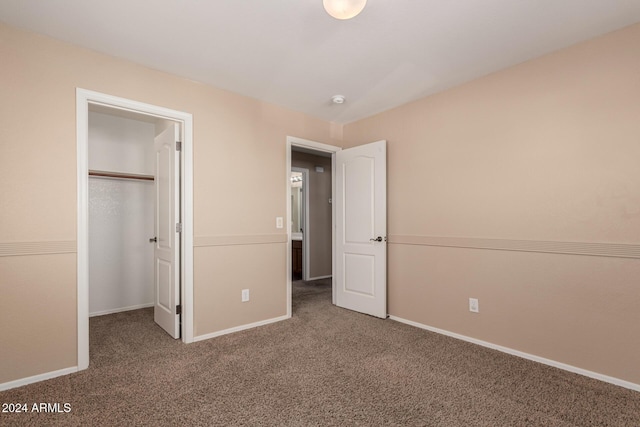 unfurnished bedroom with carpet floors and a closet