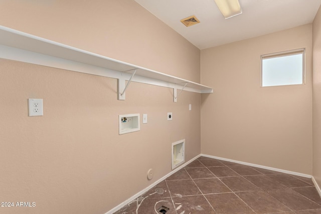 clothes washing area with electric dryer hookup, hookup for a gas dryer, hookup for a washing machine, and dark tile patterned flooring