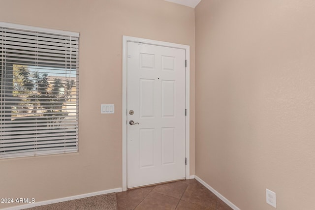 doorway to outside with tile patterned flooring