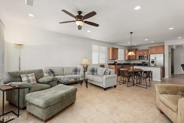 tiled living room with ceiling fan