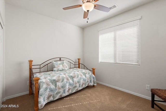 bedroom featuring ceiling fan and carpet