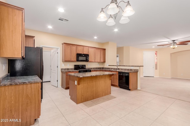 kitchen featuring decorative light fixtures, a kitchen island, black appliances, light tile patterned floors, and ceiling fan with notable chandelier