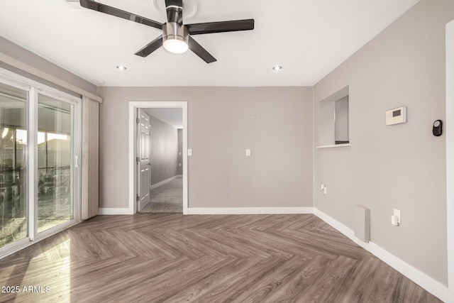 unfurnished room with a ceiling fan, baseboards, and a wealth of natural light