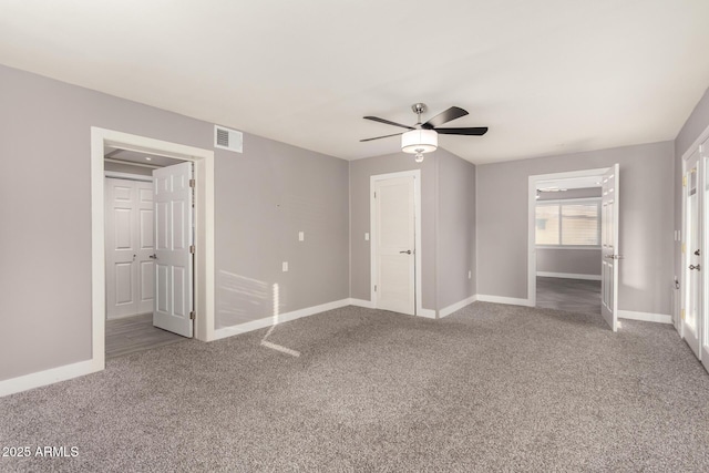 unfurnished bedroom with a ceiling fan, carpet, visible vents, and baseboards