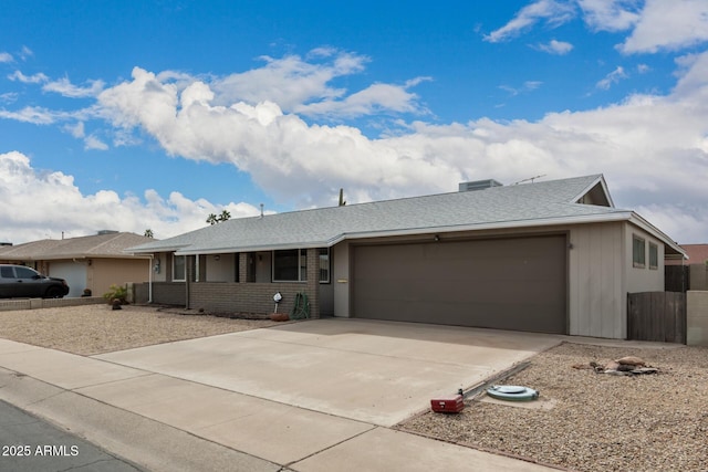 ranch-style home with brick siding, driveway, an attached garage, and roof with shingles