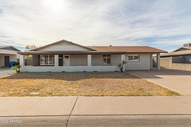 ranch-style home featuring a carport