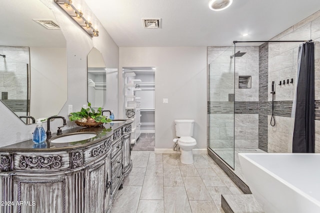 full bathroom featuring toilet, vanity, and separate shower and tub