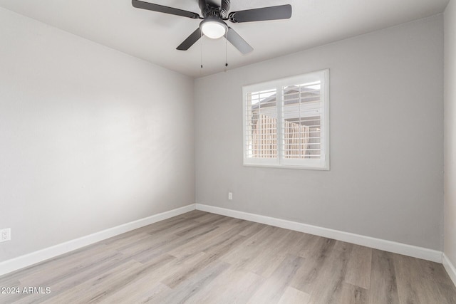 empty room with ceiling fan and light hardwood / wood-style floors