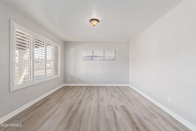 spare room with light wood-type flooring