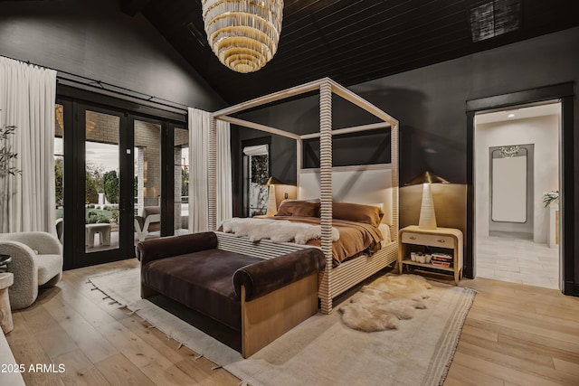 bedroom featuring high vaulted ceiling, light hardwood / wood-style flooring, and access to outside