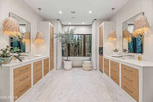 bathroom with vanity and a bathtub