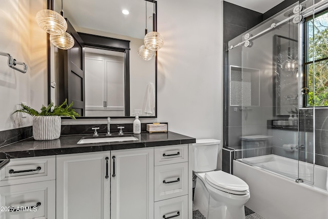 full bathroom with vanity, shower / bath combination with glass door, and toilet