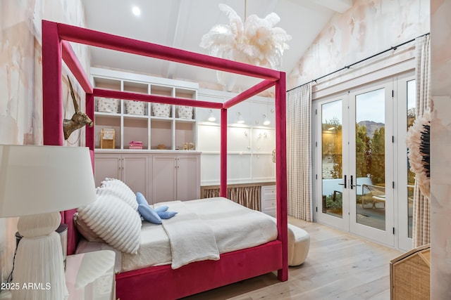 bedroom with light hardwood / wood-style flooring, access to exterior, vaulted ceiling, french doors, and a chandelier