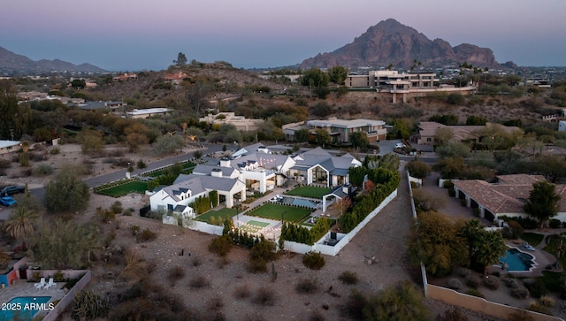 aerial view at dusk featuring a mountain view