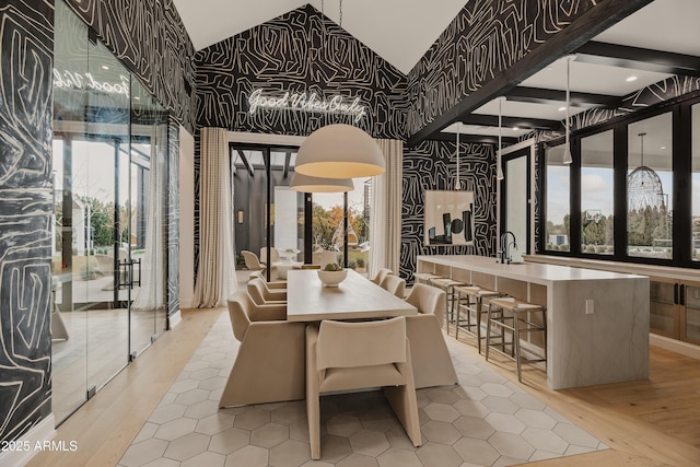 dining room with sink, light hardwood / wood-style flooring, and a healthy amount of sunlight