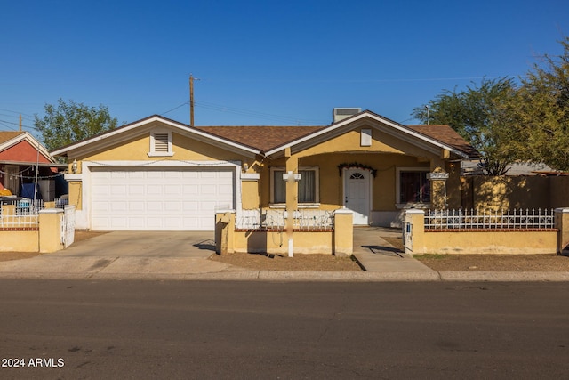 3140 W Alvarado Rd, Phoenix, AZ 85009 - ranch-style house featuring stucco siding, concrete driveway, covered porch, and a garage