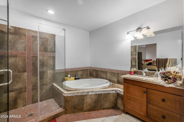 bathroom with tile patterned floors, vanity, and independent shower and bath