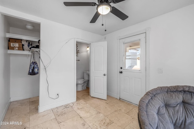 foyer entrance with ceiling fan