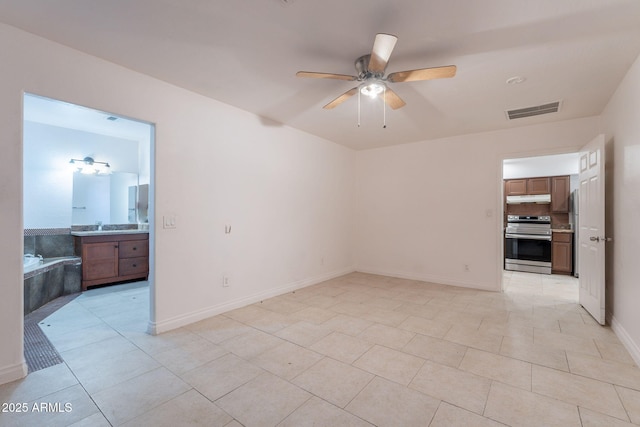 3140 W Alvarado Rd, Phoenix, AZ 85009 - spare room with ceiling fan and light tile patterned floors