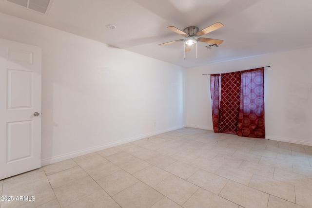 3140 W Alvarado Rd, Phoenix, AZ 85009 - empty room with ceiling fan and light tile patterned floors
