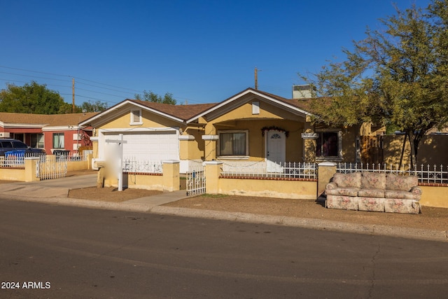 3140 W Alvarado Rd, Phoenix, AZ 85009 - view of front facade with stucco siding, a fenced front yard, concrete driveway, a chimney, and an attached garage