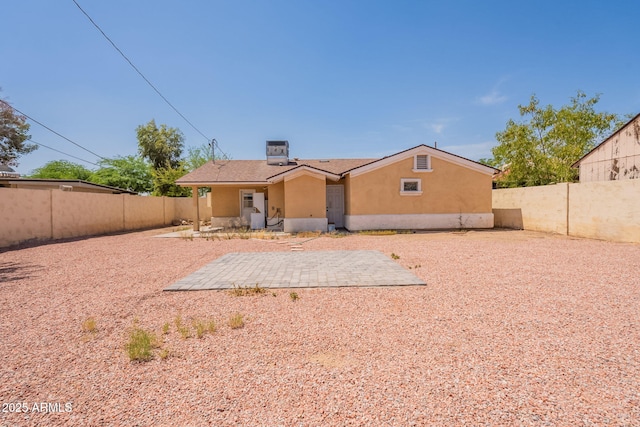 3140 W Alvarado Rd, Phoenix, AZ 85009 - rear view of property featuring stucco siding, a fenced backyard, and a patio