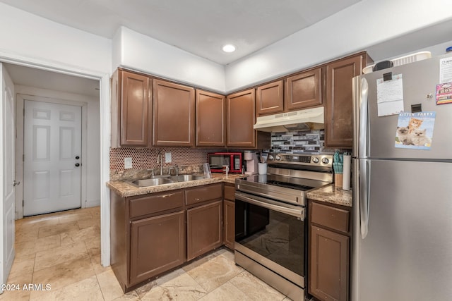 kitchen featuring sink, stainless steel appliances, and tasteful backsplash