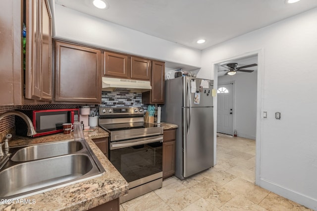 3140 W Alvarado Rd, Phoenix, AZ 85009 - kitchen with appliances with stainless steel finishes, under cabinet range hood, backsplash, a ceiling fan, and recessed lighting