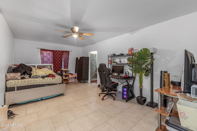 tiled bedroom featuring ceiling fan